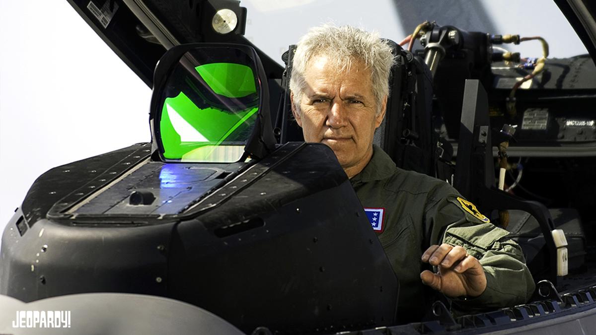 Alex Trebek in a fighter jet cockpit.