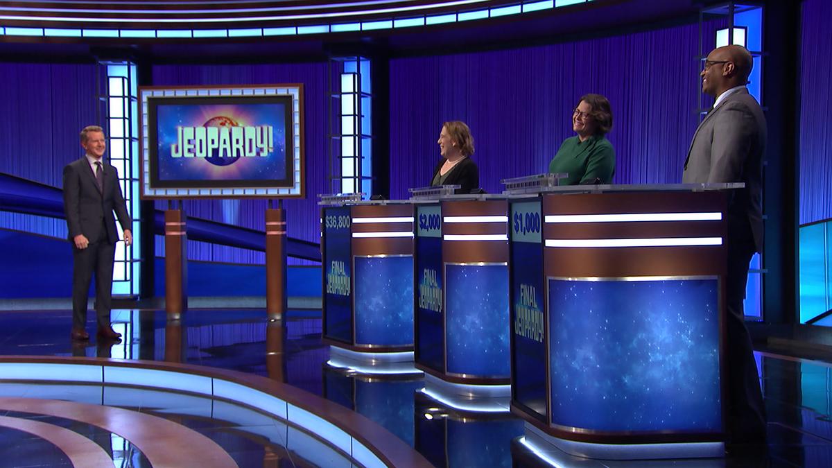 Ken Jennings and contestants on the Jeopardy! stage