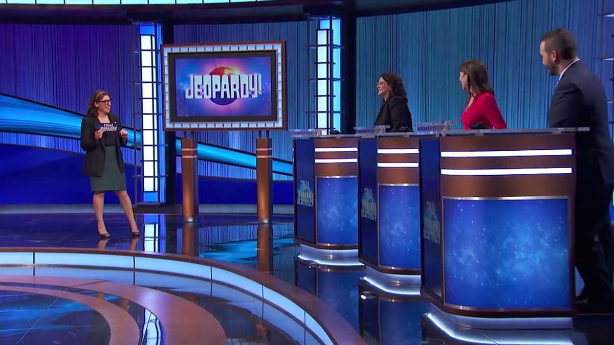 Mayim Bialik and contestants on the Jeopardy! stage