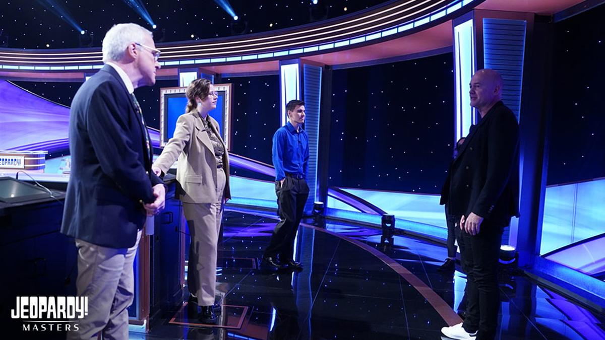 Sam Buttrey, Mattea Roach, and James Holzhauer chat with executive producer Michael Davies on set of Jeopardy! Masters