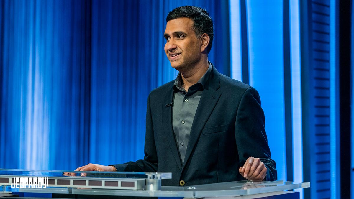 Suresh Krishnan stands behind the contestant podium 