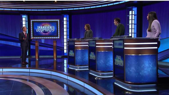 Ken Jennings and contestants on the Jeopardy! stage