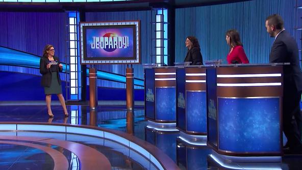 Mayim Bialik and contestants on the Jeopardy! stage