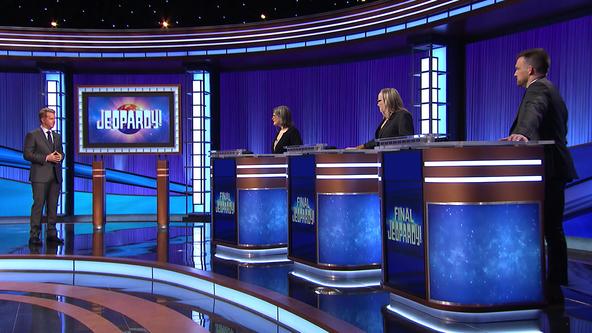 Ken Jennings and the contestants on stage. 