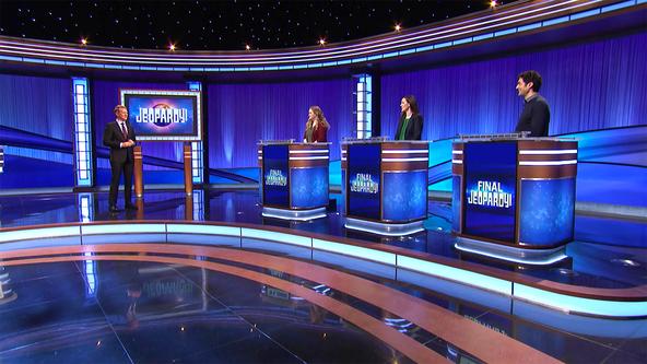 Ken Jennings and the contestants on the Jeopardy! stage.