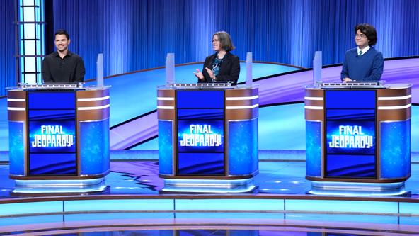 Cris Pannullo, Katy Rudolphy and John Dorsey on behind the contestant podiums on the Alex Trebek Stage.