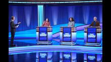 Host Ken Jennings and contestants Amy Hummel, Grant DeYoung and David Erb on the Jeopardy! set.